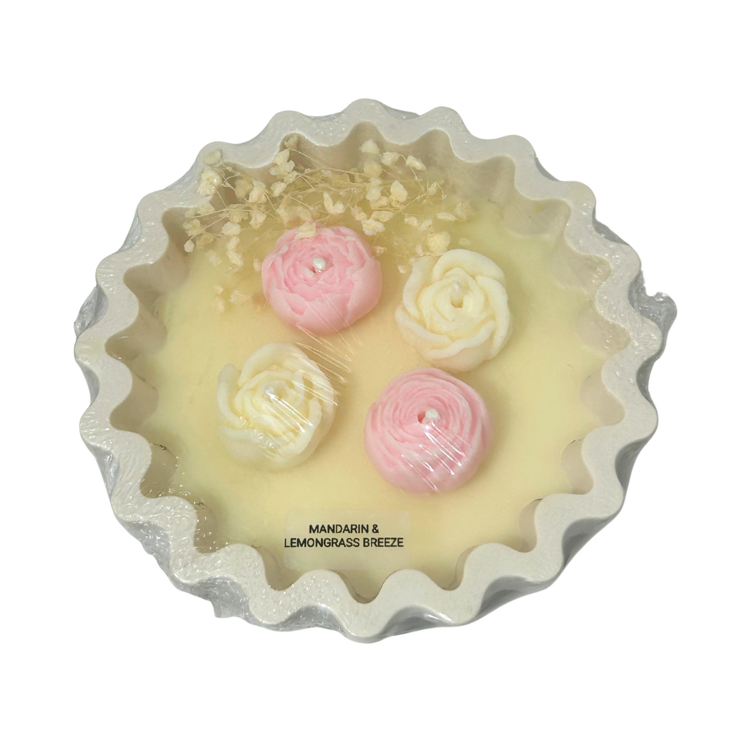 Decorative candle with pink and white floral designs on a white background