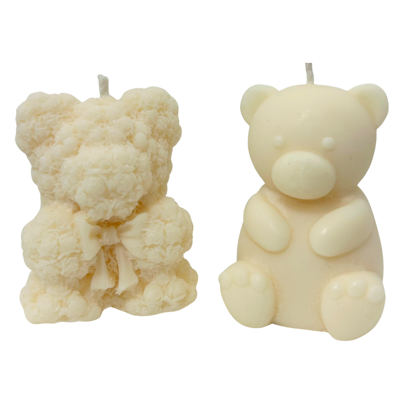 Two bear-shaped candles on a white background