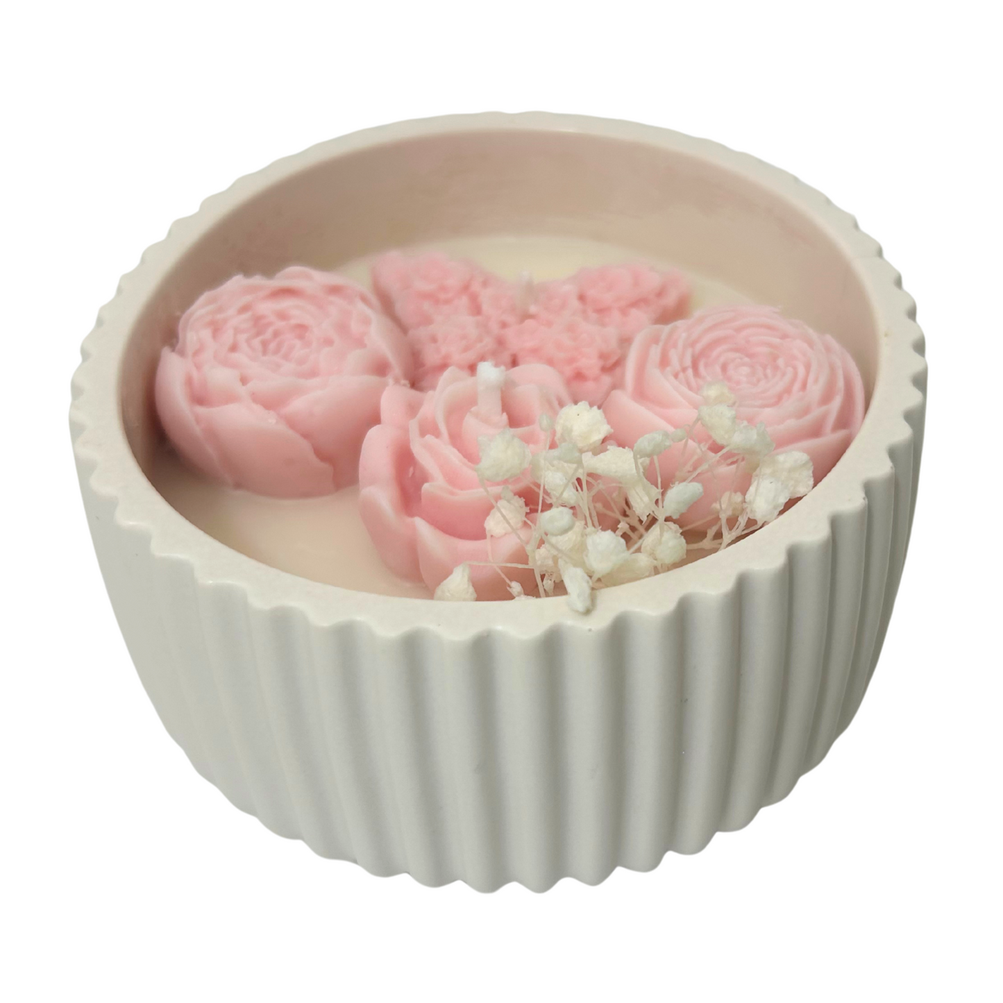 Candle with pink flowers in a Jesmonite bowl on a white background