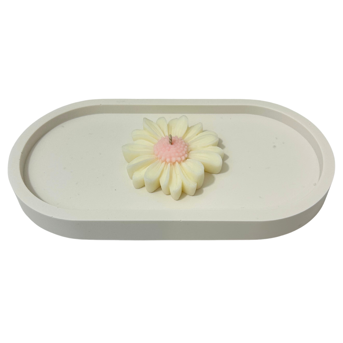 White ceramic tray with a Daisy shaped candle on a white background