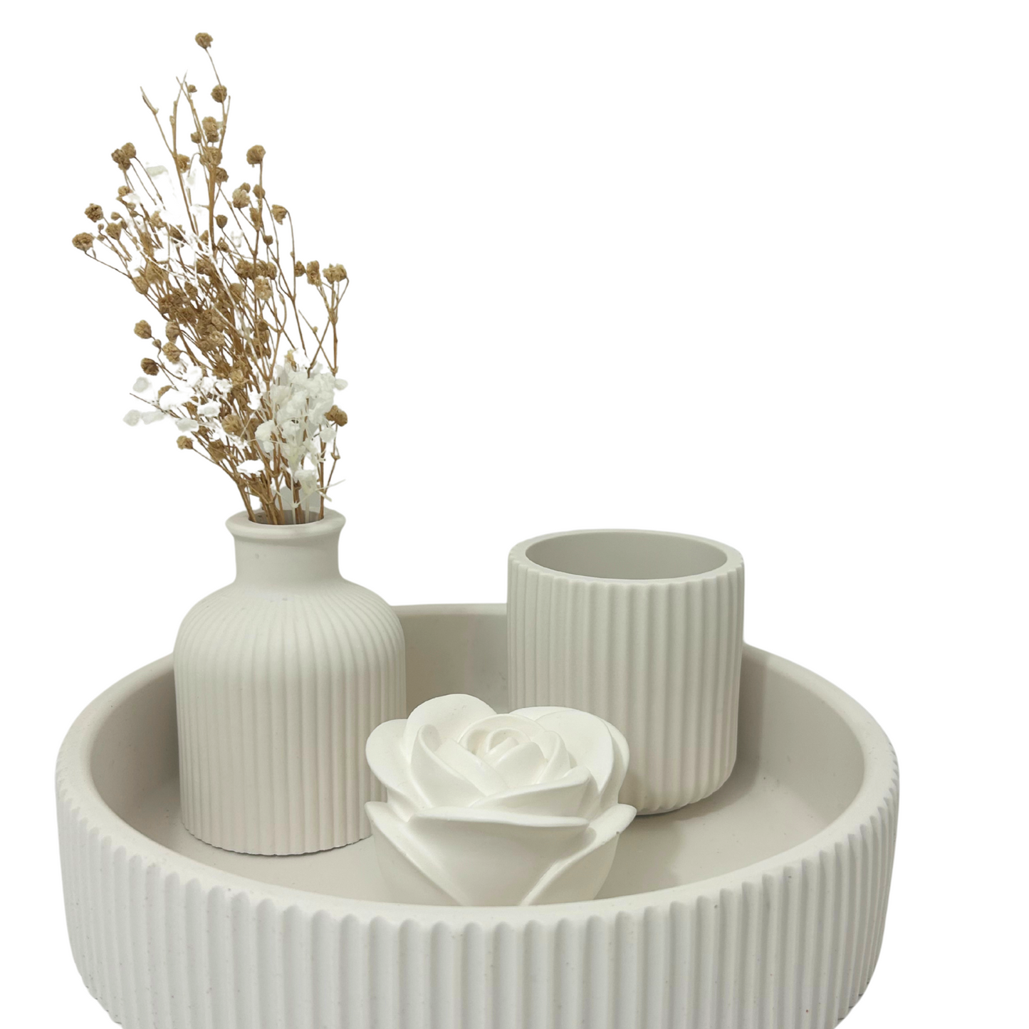 Decorative set with a vase, candle, and flower arrangement on a white background