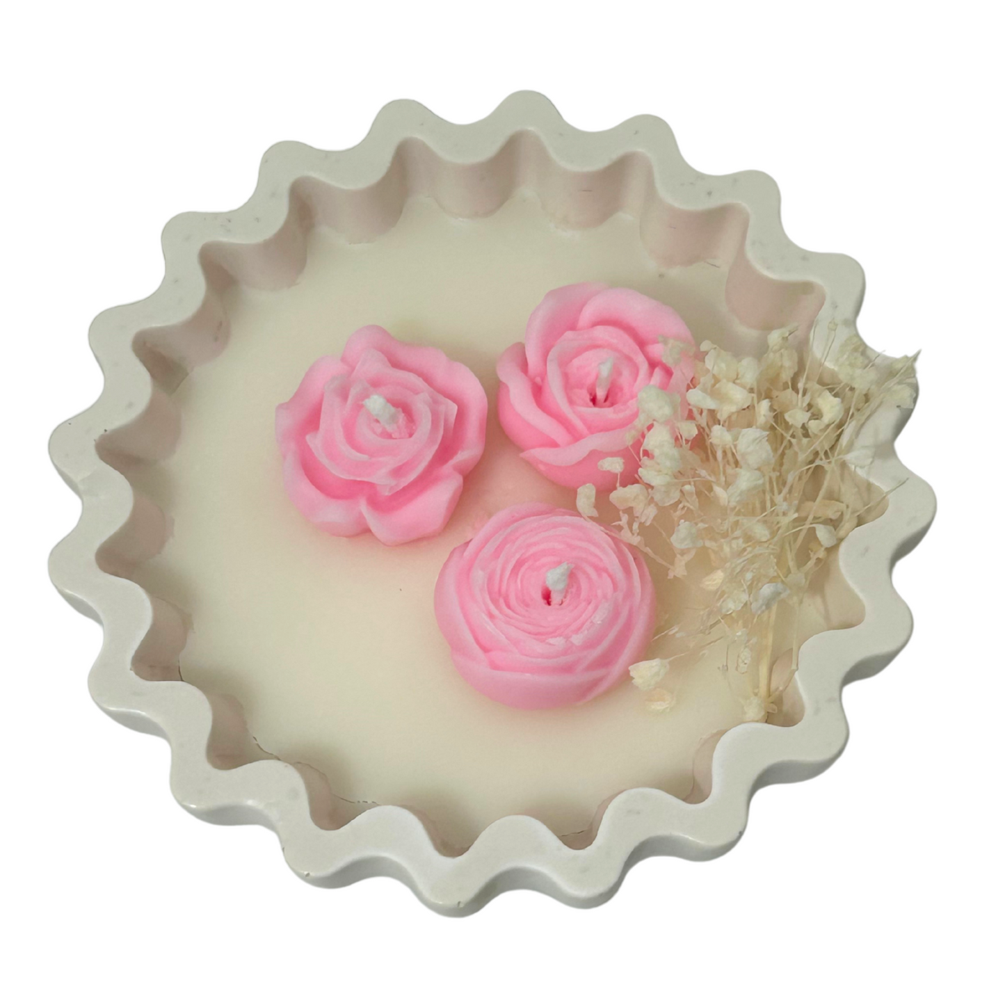 Decorative CANDLE with pink rose-shaped candles and dried flowers on a white background