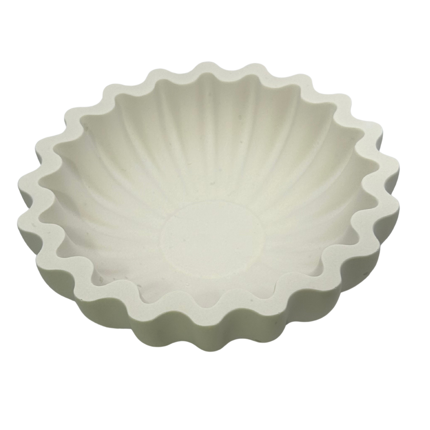 White wavy edge sea shell style dish on a white background