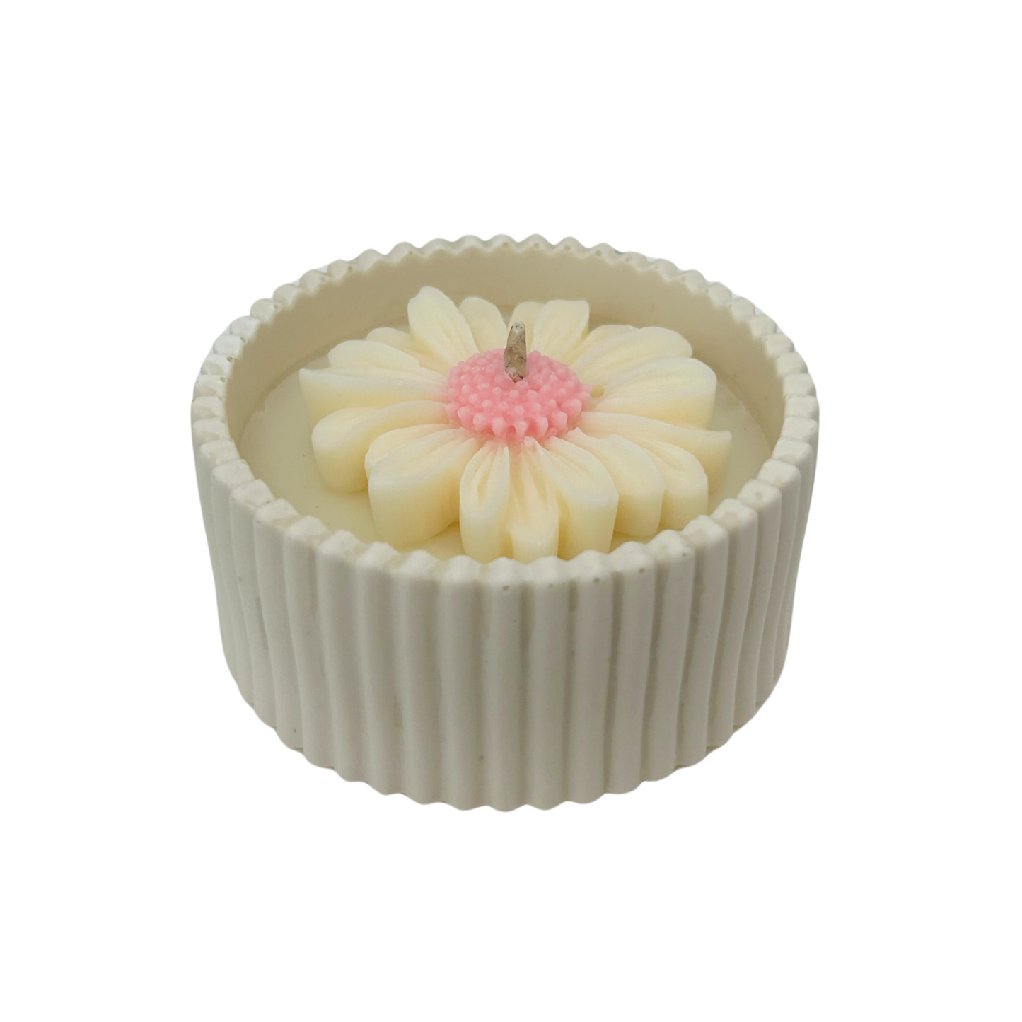 Candle with a daisy design in a ribbed container on a white background