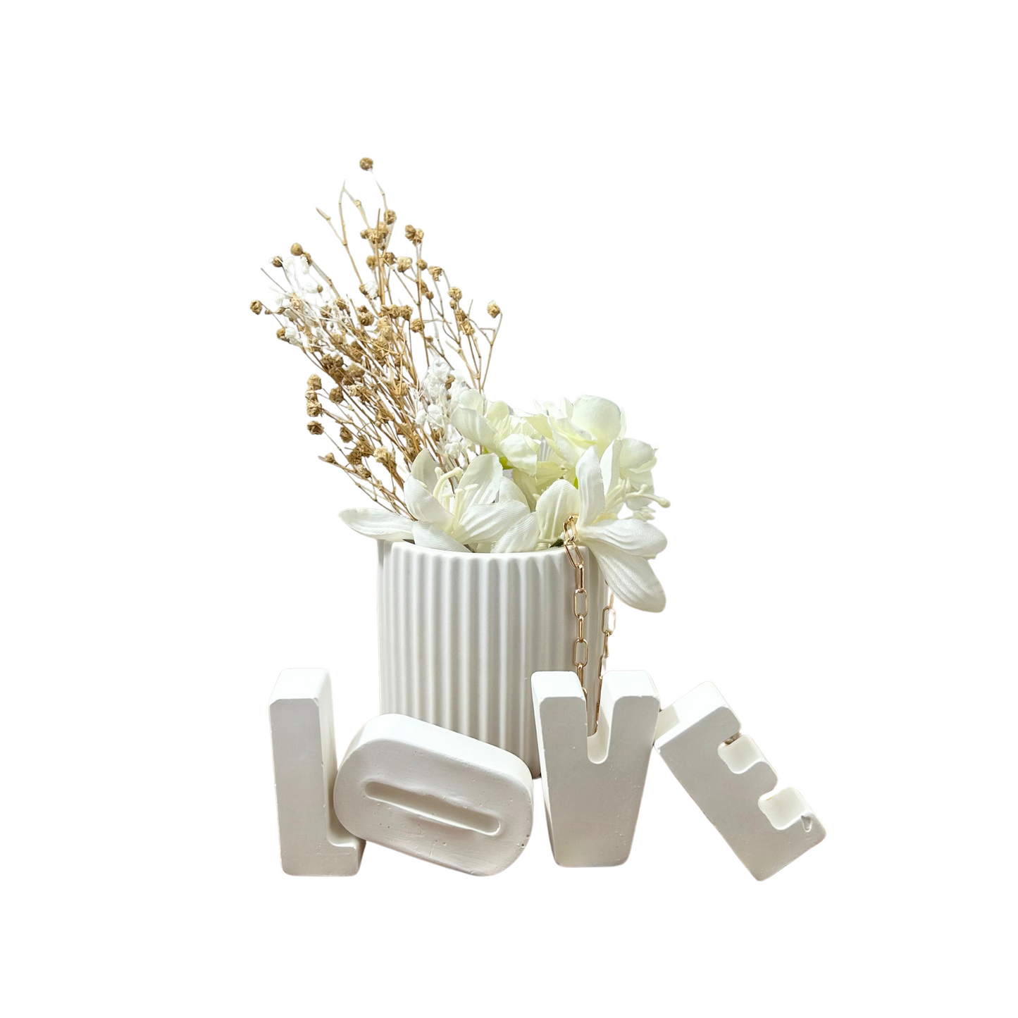 Decorative arrangement with flowers in a jesmonite vase and 'LOVE' letters on a white background