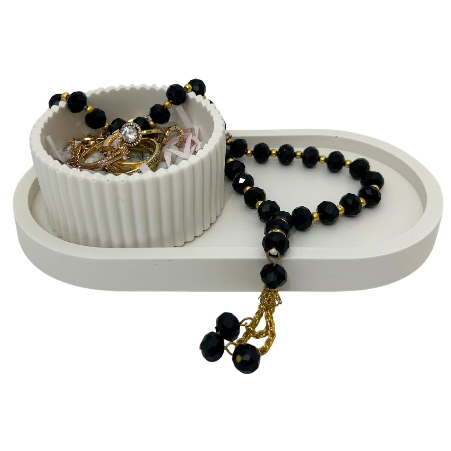 White jewelry organizer with black and gold beads on a white background