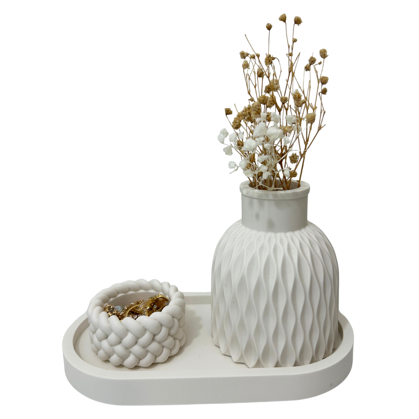 White textured vase with dried flowers on a matching tray against a white background