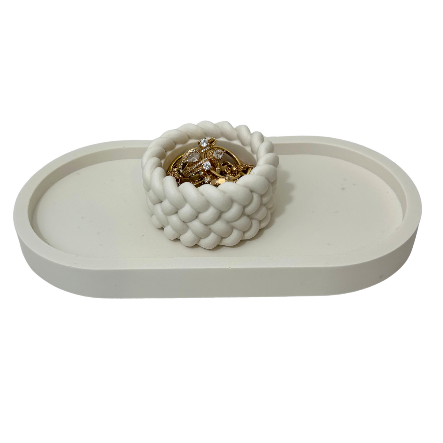 White woven jar with jewelry on a white tray