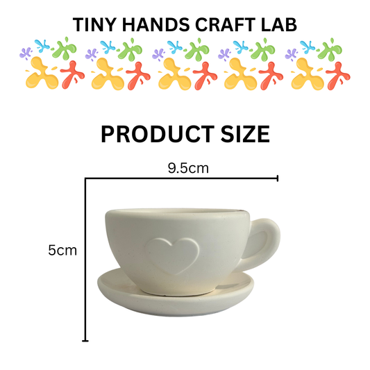 White cup and saucer with heart design, labeled 'Tiny Hands Craft Lab' and product size measurements.