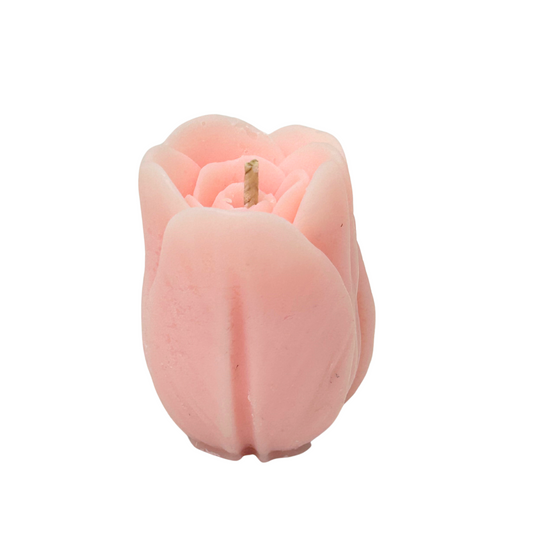 Pink tulip-shaped candle on a white background