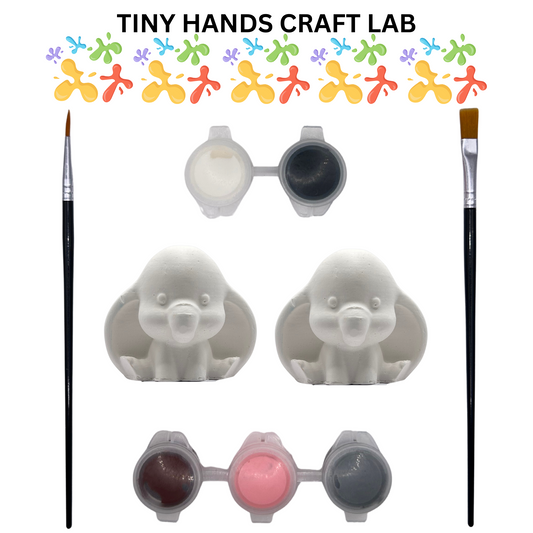 Craft supplies including two dumbo the elephant figurines, a paintbrush, and small containers of paint on a white background with 'Tiny Hands Craft Lab' branding.