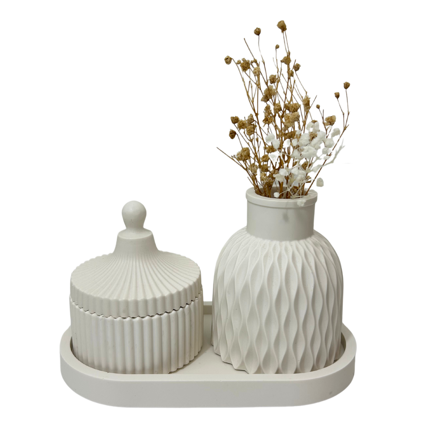 White jesmonite jar with lid and decorative vase with dried flowers on a white background