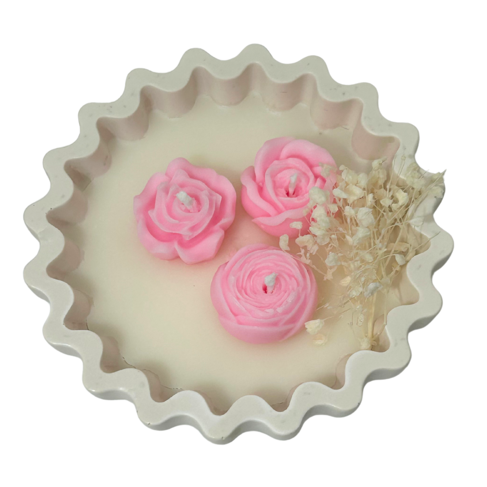 Decorative CANDLE with pink rose-shaped candles and dried flowers on a white background