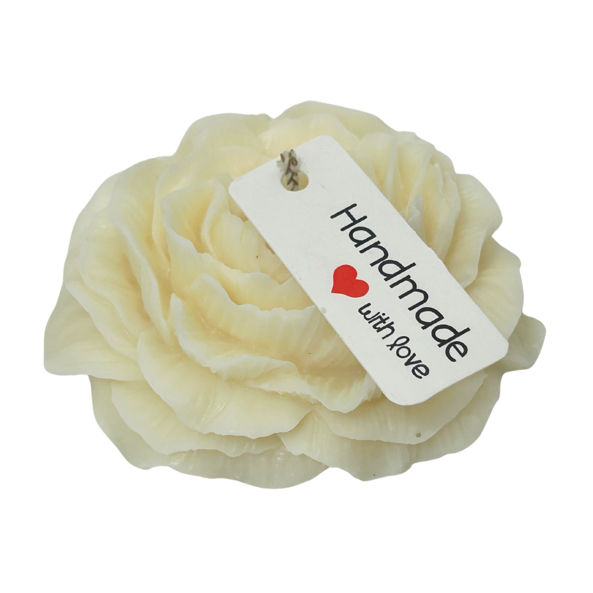 Cream-colored flower-shaped candle with a 'Handmade with Love' tag on a white background