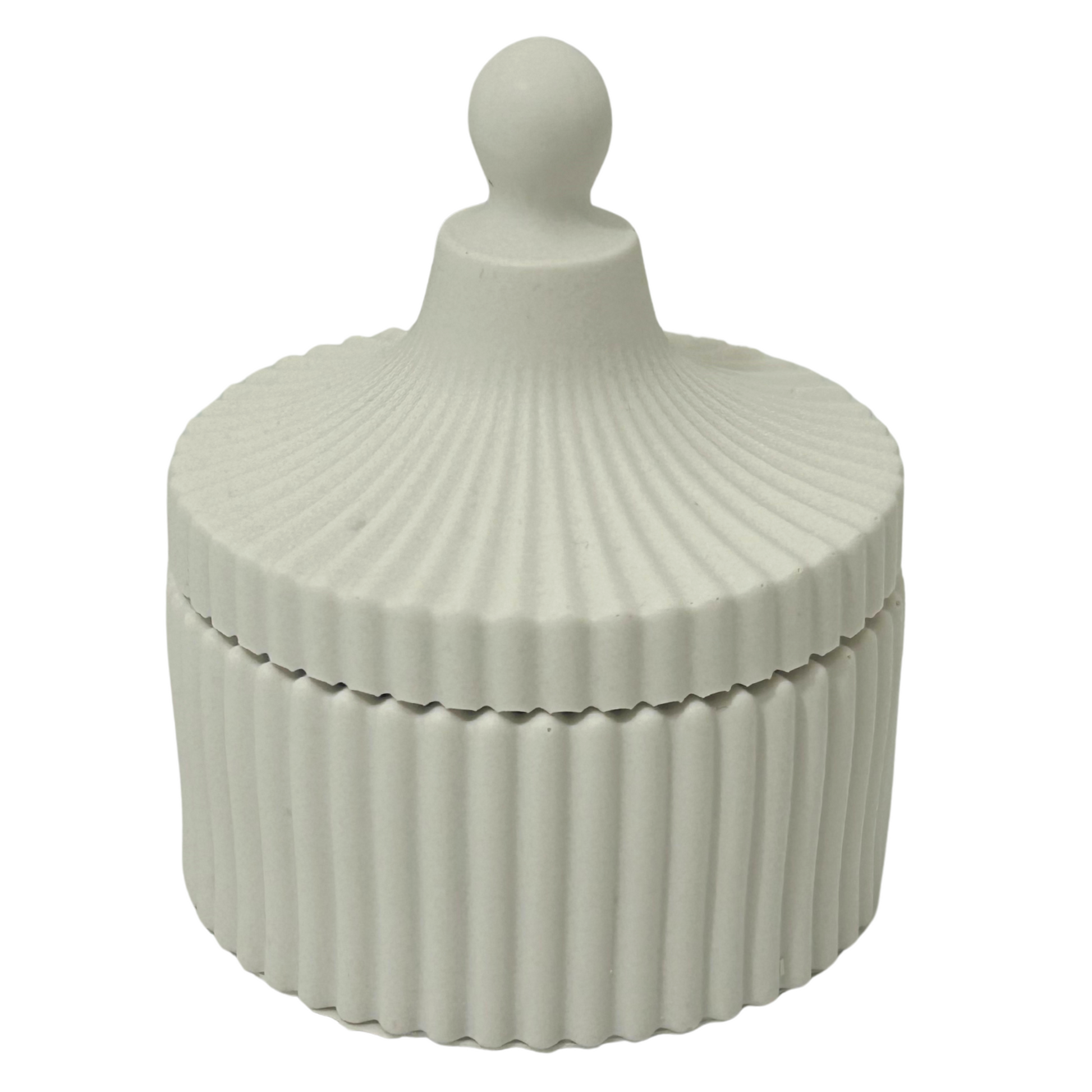 Jesmonite ribbed decorative box with a spherical finial on a white background
